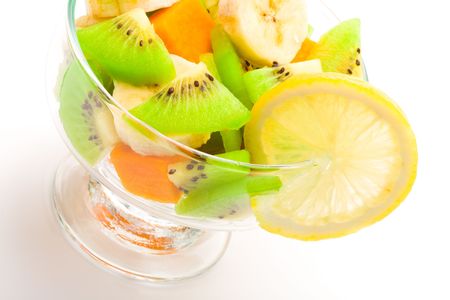 Cocktail of tropical fruits decorated lemon slice on a white backgroundの写真素材