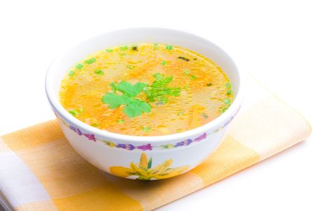 Bowl of chicken soup over yellow napkin on a white backgroundの写真素材