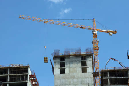 A building under construction and a crane.