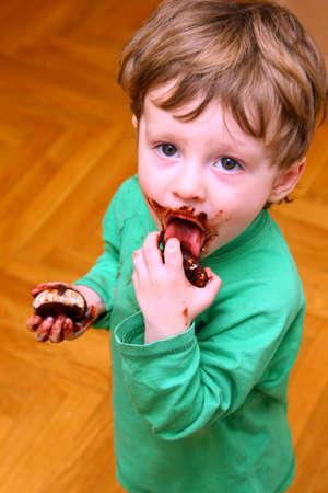 The little boy enjoying a zephyr in chocolateの写真素材