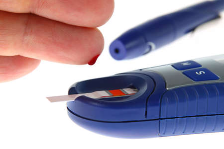 Diabetic is doing a glucose level finger blood test