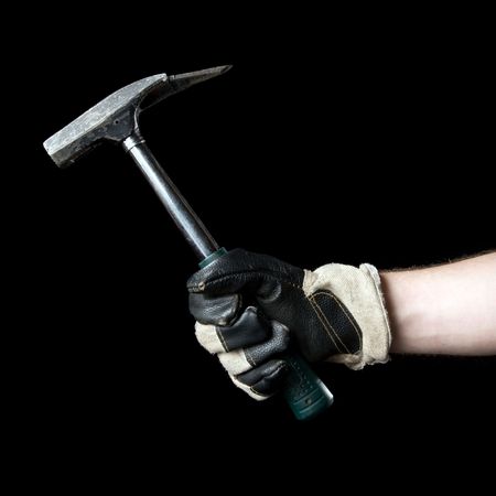 Hammer in hand. Isolated on a black background.の写真素材