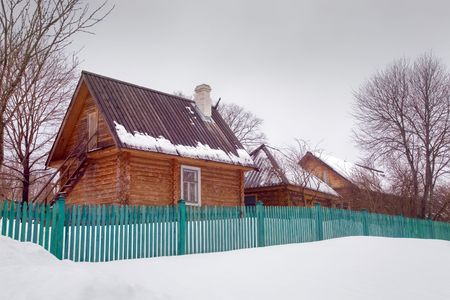 The timbered rural house behind a fenceの写真素材
