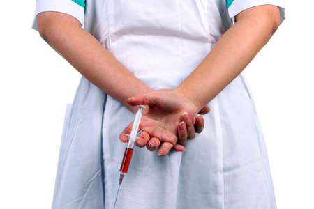 The nurse with a syringe in hands on a white background.の写真素材