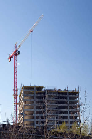 Crane working on a building site in city
