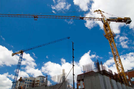 The building crane on a background of the blue sky