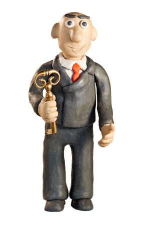 plasticine businessman with key over white backgroundの写真素材