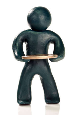 Plasticine person with a coin on white backgroundの写真素材