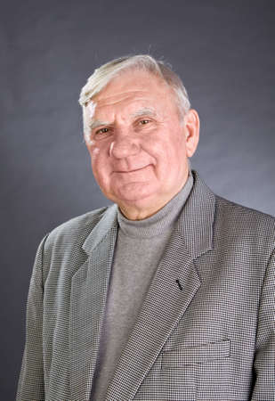 Portrait of elderly man ?n a grey background
