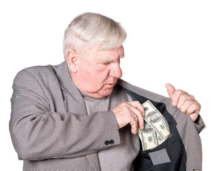 Elderly man puts money in an internal pocket of a jacket. It is isolated on a white backgroundの写真素材