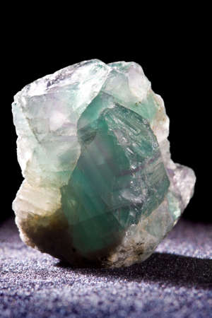 Diopside mineral stone on a black backgroundの写真素材