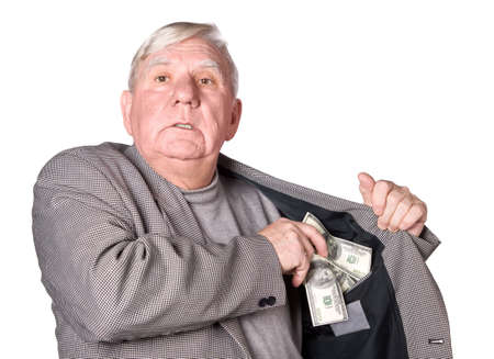 Elderly man puts money in an internal pocket of a jacket. It is isolated on a white backgroundの写真素材