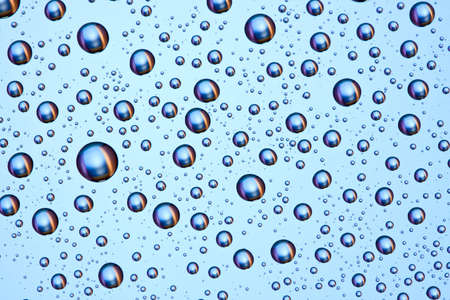 Water droplets on a transparent glass surface