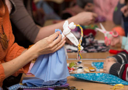 Russian folk crafts. Making rag doll Vesnyankaの写真素材