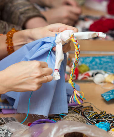 Russian folk crafts. Making rag doll Vesnyankaの写真素材