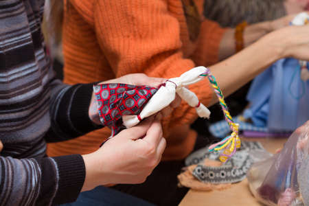 Russian folk crafts. Making rag doll Vesnyankaの写真素材