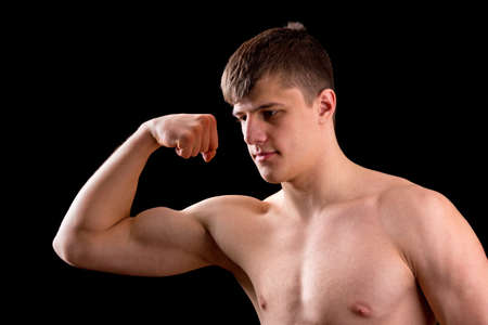 Young muscular man on a black backgroundの写真素材