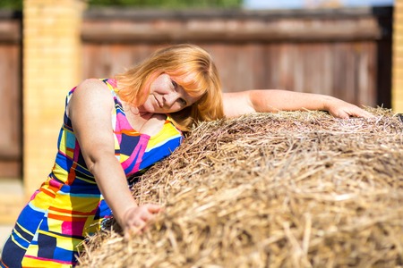 Portrait of a woman near a haystackの写真素材