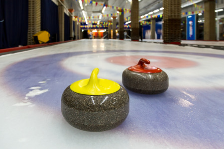 Curling stone on ice of a indoors rink