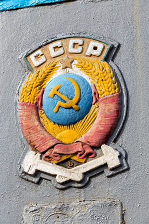 The coat of arms of the Soviet Union aboard obsolete railroad carの写真素材
