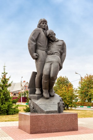 Prokhorovka, Russia - October 6, 2015: Sculptural composition tankman and infantryman. The sculpture, made in the style of Soviet monumentalism, depicts of tankman in headset standing and supporting a wounded infantryman.のeditorial素材