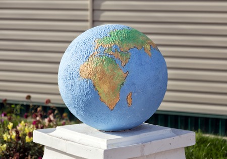 Outdoor decorative sculpture Globe in the village Hlevnoe. Russia