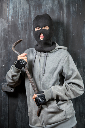 Portrait of a burglar with a crowbarの写真素材