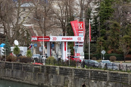 Sochi, Russia - February 8, 2016: Lukoil gas station with fueling car. LUKOIL - one of the largest Russian oil company.のeditorial素材