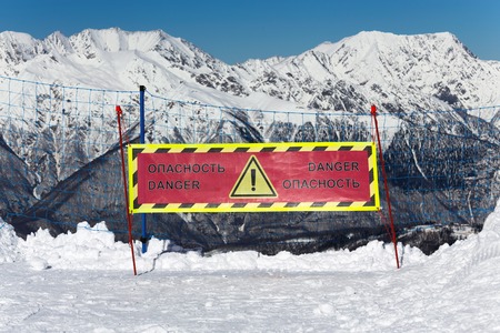 A warning sign of a possible fall from the mountainの写真素材