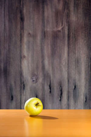 Yellow apple on the tableの写真素材