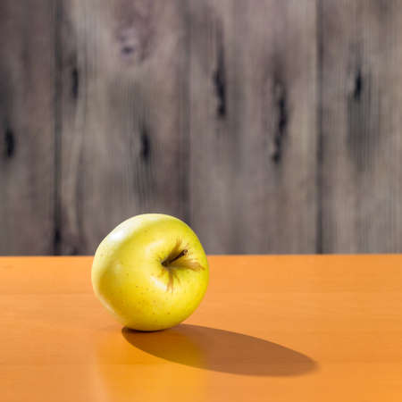 Yellow apple on the tableの写真素材