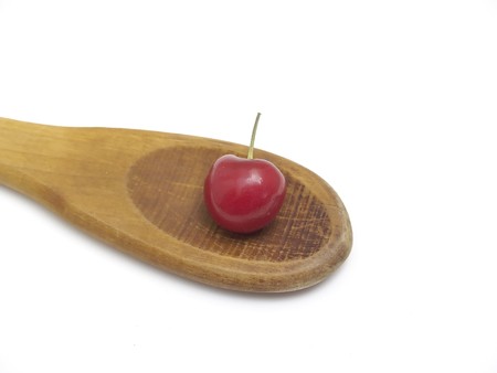 cherry in wood spoonの写真素材