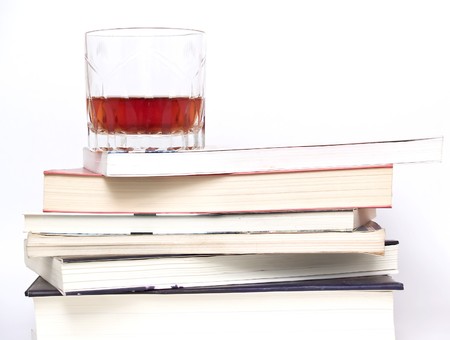 glass of whiskey on booksの写真素材