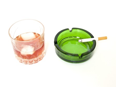 glass of whiskey, cigarettes and ashtrayの写真素材