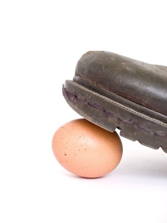 leather boots treading an eggの写真素材