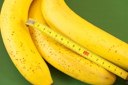 bananas with tape measureの写真素材
