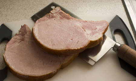 smoked pork chops on cutting board with knife
