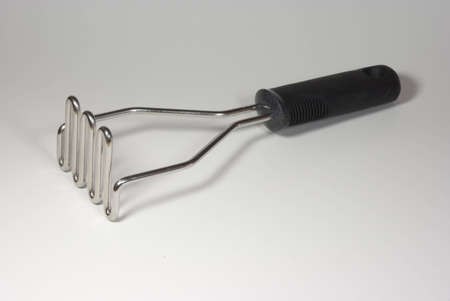 stainless steel potato masher with black handleの写真素材
