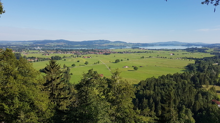 Panoramic view from Alps, Bavaria. Beautiful peaceful landscape, summertime. Blue sky with some...