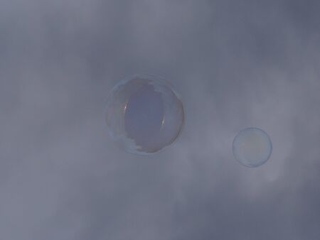 Soap bubble in a cloudy sky