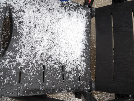 Hail storm on the bench in the park. Snow on the bench.の写真素材