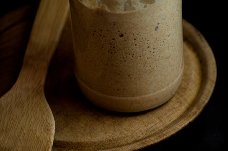 sourdough on wooden plate, natural yeast ready to bake organic wholemeal breadの写真素材