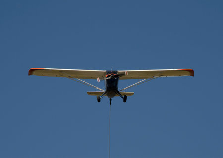 plane from the front flying with the propeller in motion with a blue sky in the backgroundの写真素材