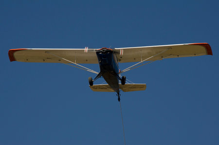 plane from the front flying with the propeller in motion with a blue sky in the background