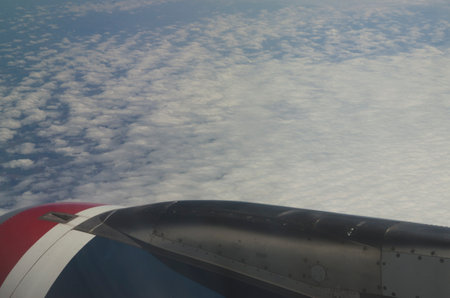 commercial airplane, engine seen from the window on tourist trip, flying at high altitude