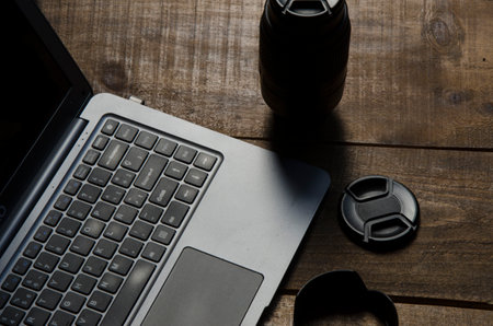 laptop and coffee cup on wooden table, work from home conceptの写真素材