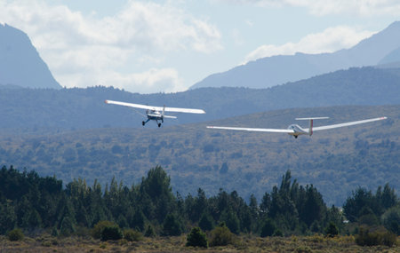 ultralight glider towed by propeller plane