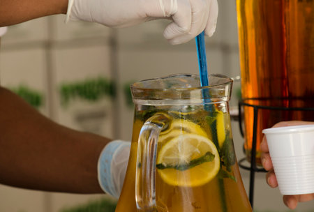 serving glass jar lemonade with safety and health protocols. Apple juice with lemonの写真素材