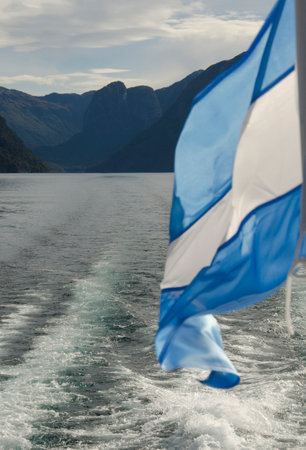 Argentina flag profile with water in the background. flag of the Argentine nation light blue and...