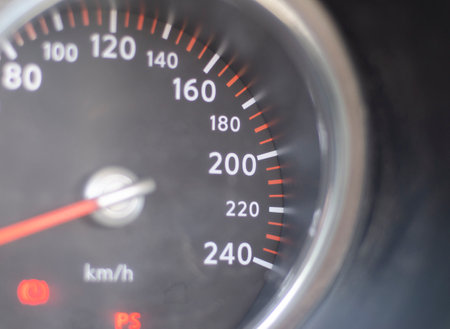 Speedometer with the 200 km per hour sign in the foreground. car speed